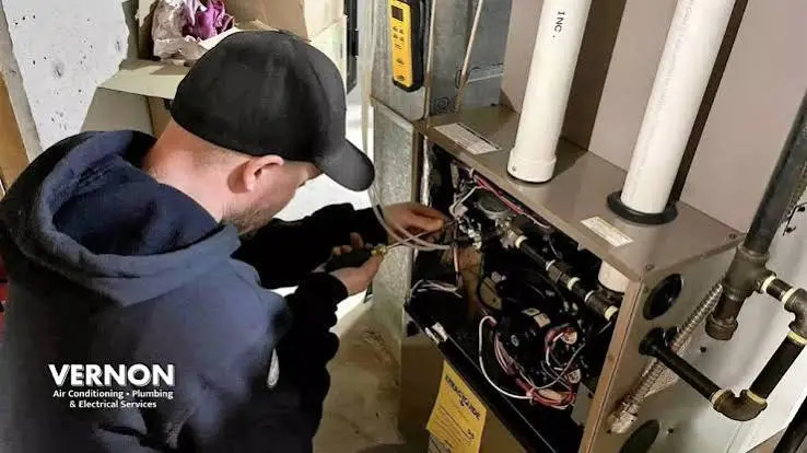 HVAC technician working on a system during a Peoria service call