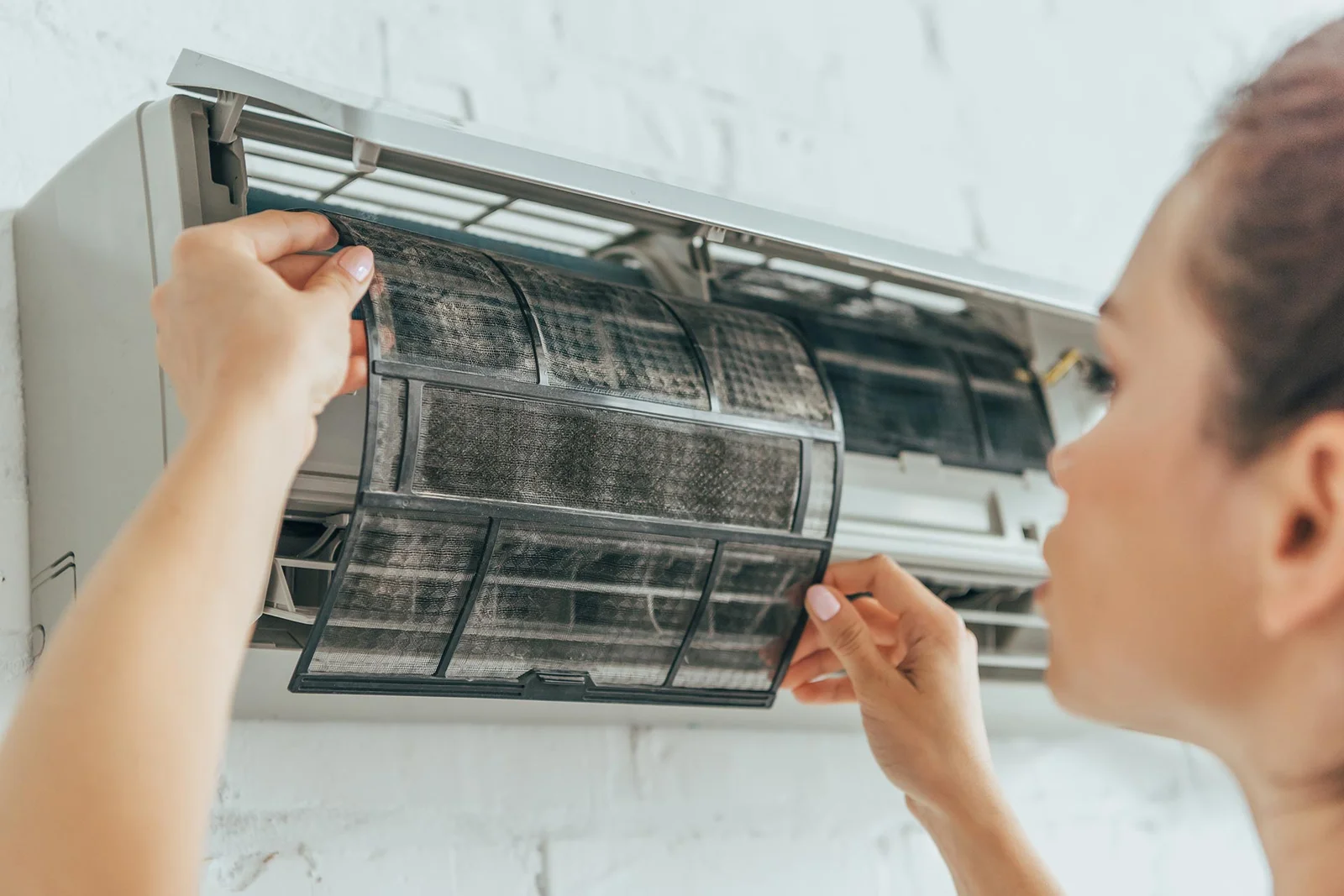 HVAC technician working on an air conditioning system during a Peoria service call