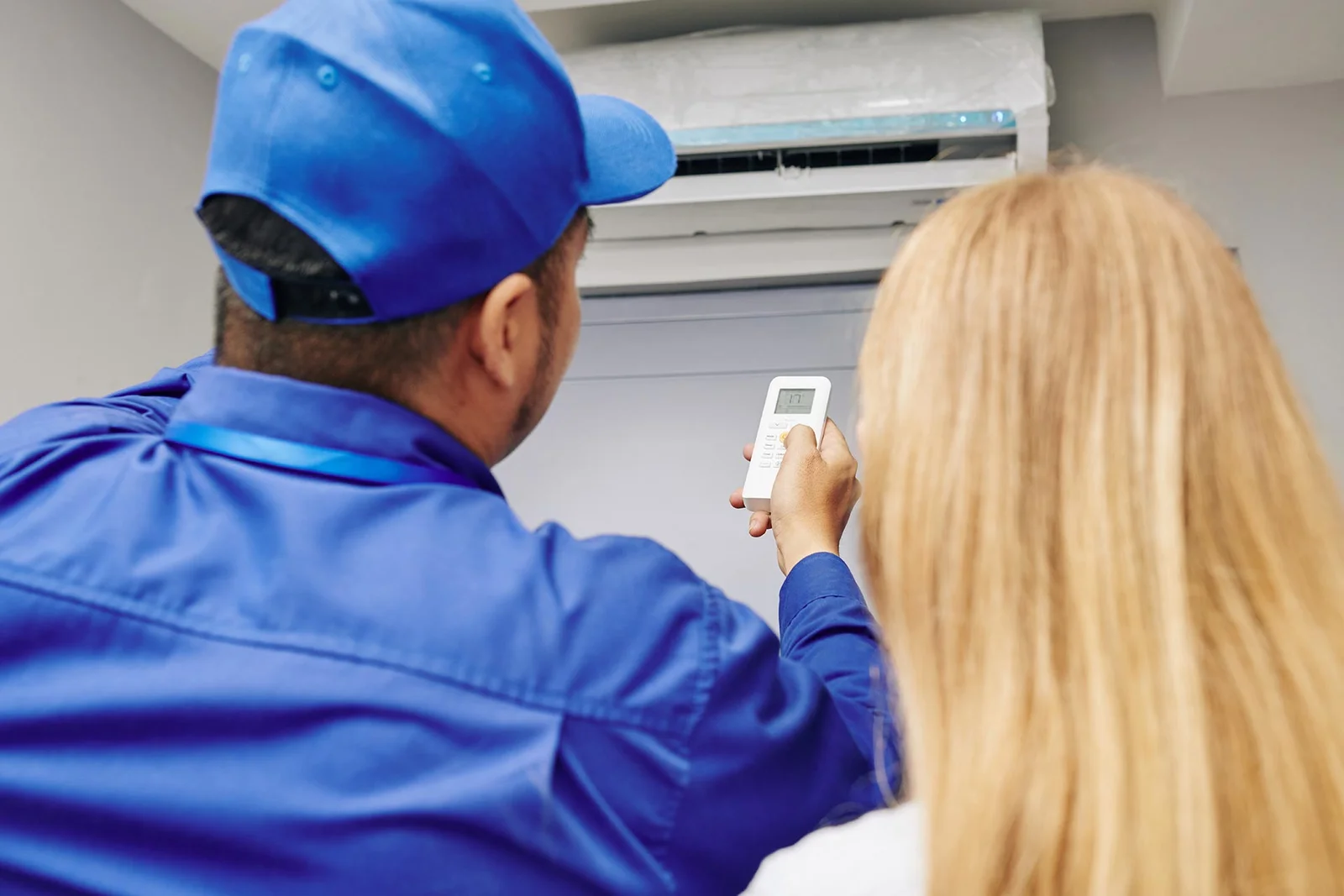 HVAC technician explains the repaired thermostat to a Peoria homeowner after a same-day furnace fix