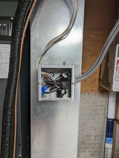 Close-up of HVAC condenser and ductwork components, the type of equipment serviced across the Peoria Tri-County Area